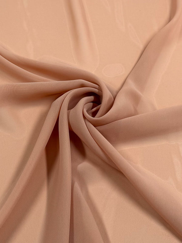 A close-up of Super Cheap Fabrics' Hi-Multi Chiffon in Pink Sand (150cm), showing its lightweight, sheer texture arranged in soft, flowing folds with a spiral twist at the center.
