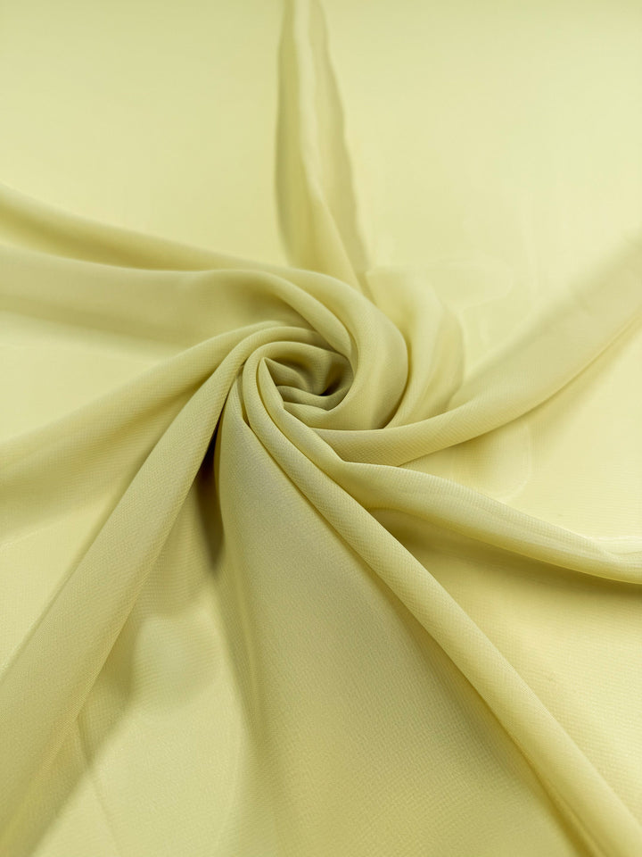 Hi-Multi Chiffon in Shadow Green from Super Cheap Fabrics is displayed in soft spirals, showing off its lightweight, sheer polyester texture. Fabric width: 150cm.