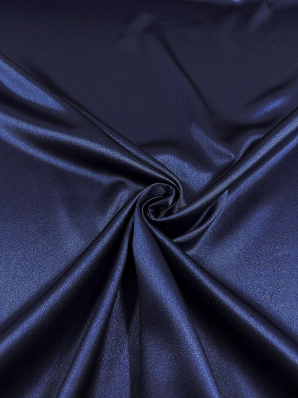Super Cheap Fabrics' Satin Back Crepe - Galaxy Blue (150cm) is elegantly gathered at the center, forming a gentle spiral of smooth, reflective folds and soft highlights.