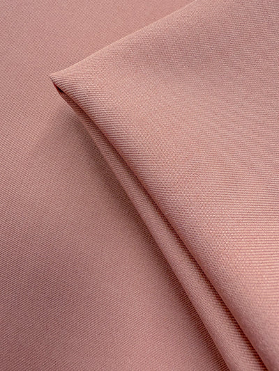 A close-up of Super Cheap Fabrics’ Liquid Twill - Misty Rose (150cm), showing its fine, smooth texture and subtle diagonal lines for a soft, elegant finish.