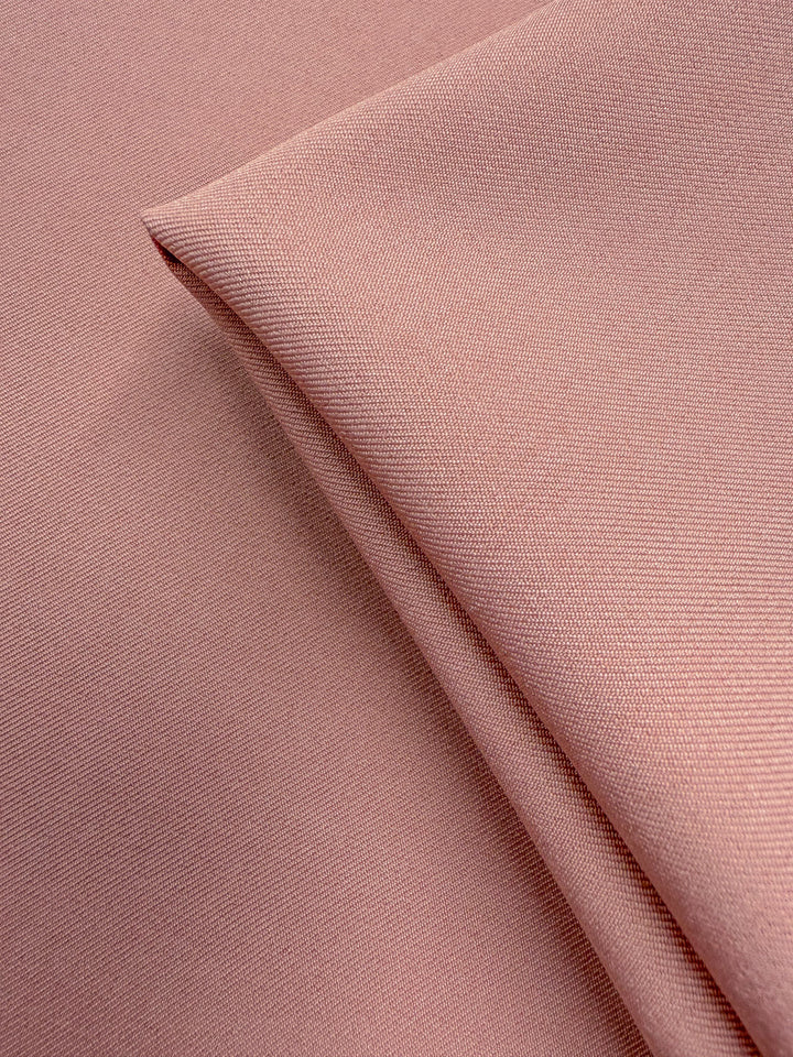 A close-up of Super Cheap Fabrics’ Liquid Twill - Misty Rose (150cm), showing its fine, smooth texture and subtle diagonal lines for a soft, elegant finish.
