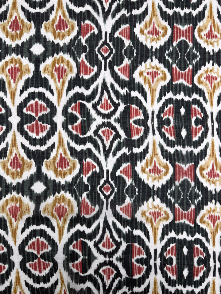 Close-up of Super Cheap Fabrics' Textured Designer Cotton - Spice Loom (150cm), a lightweight quilting fabric with visible texture and intricate repeating abstract shapes in black, white, reddish-brown, and golden-yellow.