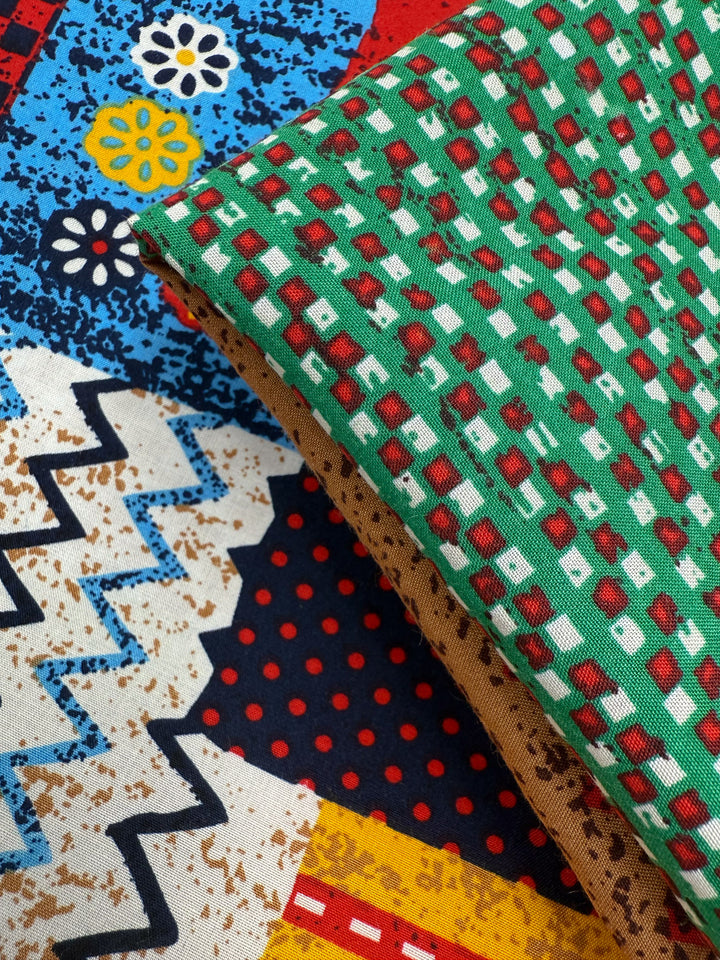 Two pieces of lightweight Designer Rayon – Andes Patchwork (147cm) by Super Cheap Fabrics: one features a geometric green, red, and white design; the other shows vibrant abstract shapes, zigzags, dots, and florals in blue, red, yellow, black, and white.