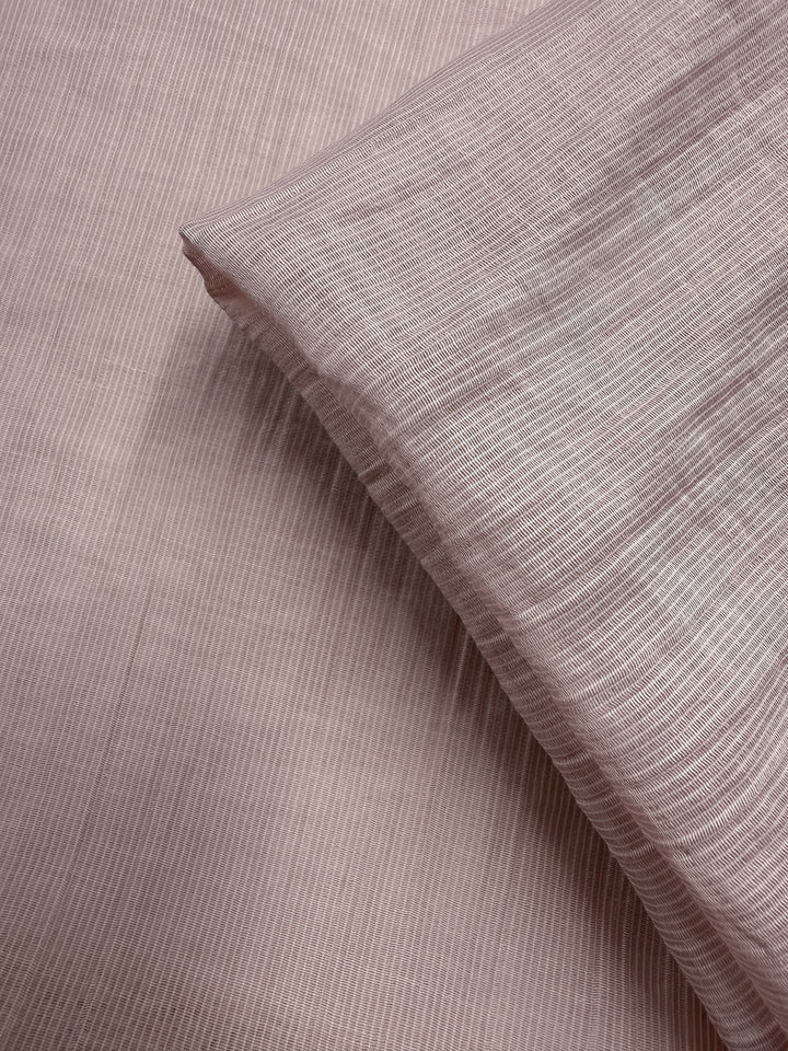 Close-up of Super Cheap Fabrics' Textured Designer Voile in Sepia Rose (155cm): light pink, lightweight cotton with subtle vertical stripes, softly folded against a matching background—ideal for summer dresses.