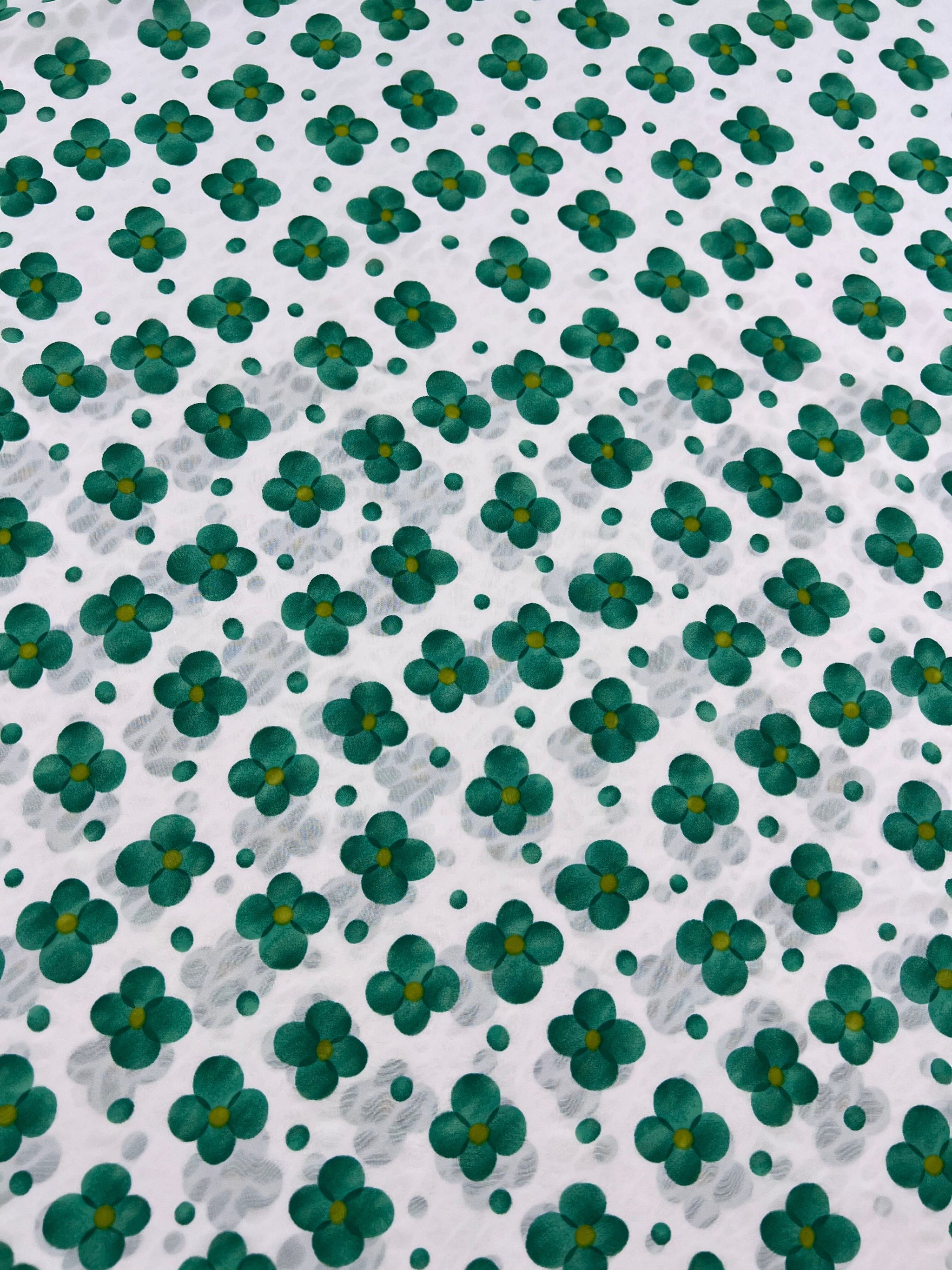 The Salt Shrunk Print - Clover by Super Cheap Fabrics features a vibrant pattern of green and yellow flowers arranged on a white background, creating an evenly spaced, repetitive design across the 155cm wide fabric.