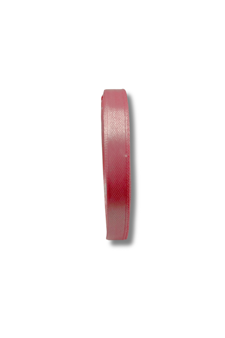 A spool of Super Cheap Fabrics Satin Ribbon - 10 Colours - 10mm, pink, 21m long, is shown from the side on a plain white background with a faint shadow cast to the right.