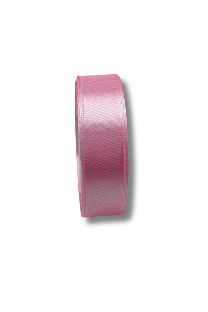 A roll of Super Cheap Fabrics’ Satin Ribbon - 16 Colours - 25mm stands upright on a white background, casting a faint shadow to the right.