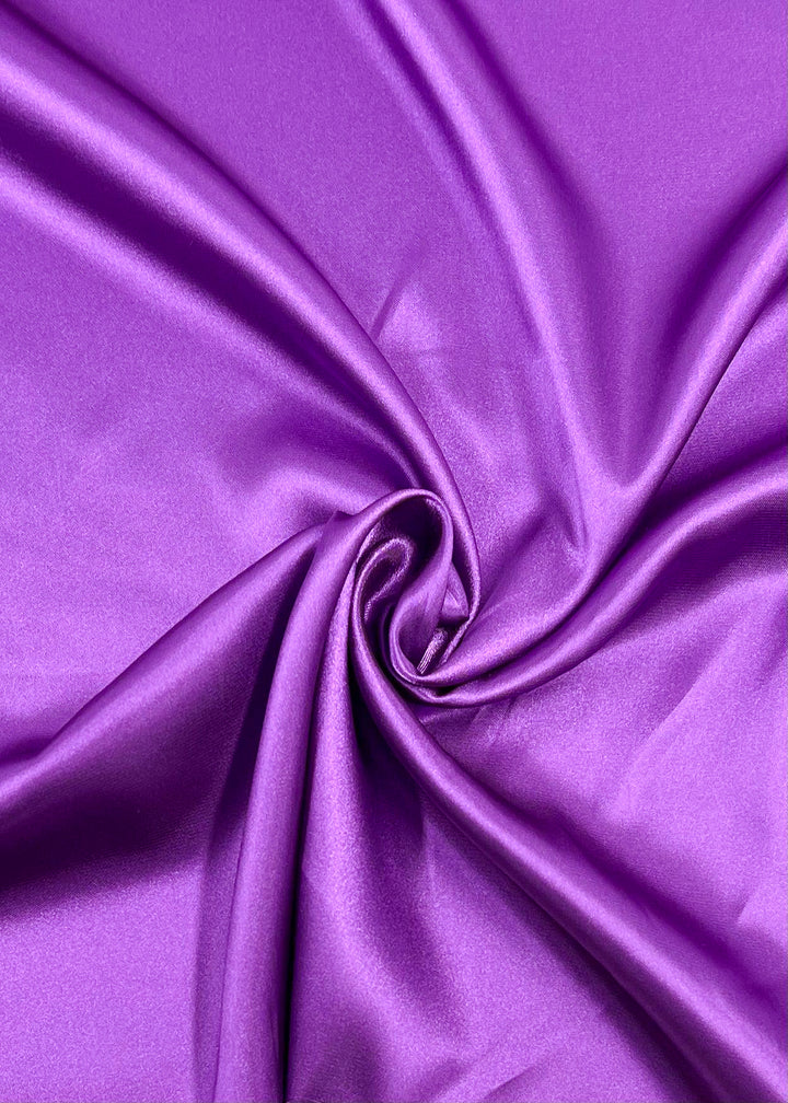 Super Cheap Fabrics' Satin - Hyacinth Orchid (150cm) features smooth, shiny purple fabric with soft center gathers and glossy texture—ideal for luxurious dressmaking projects.