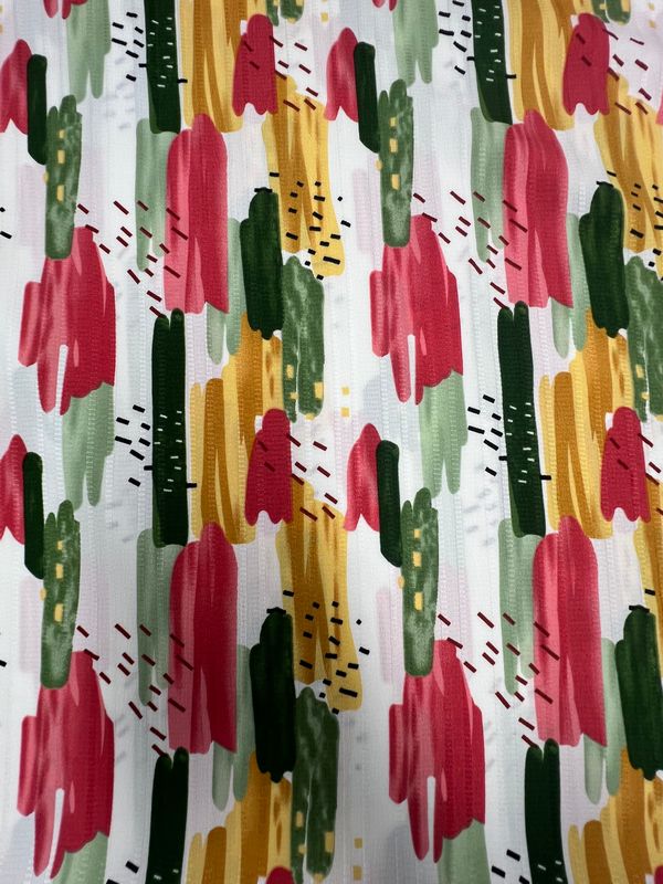 The Textured Deluxe Print - Stroke & Speck 2.0 (155cm) by Super Cheap Fabrics features a colorful abstract pattern of vertical red, green, yellow, and black brushstrokes on white—ideal for versatile fabric or polyester print projects.