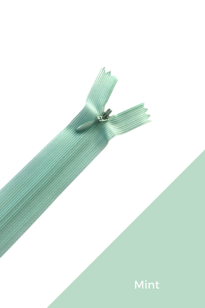 The Super Cheap Fabrics Invisible Zip - 30cm - Greens is shown diagonally on a white and mint color-blocked background, with "Mint" in white text in the lower right corner.