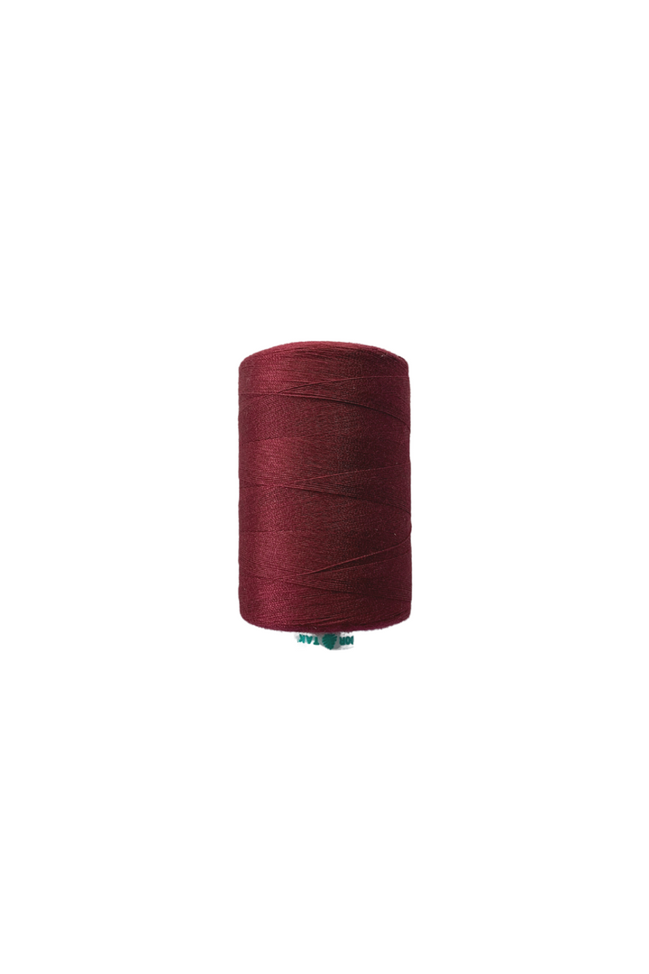 On a white background, the burgundy hue of Super Cheap Fabrics' "Thread - Burgundy" stands out beautifully.