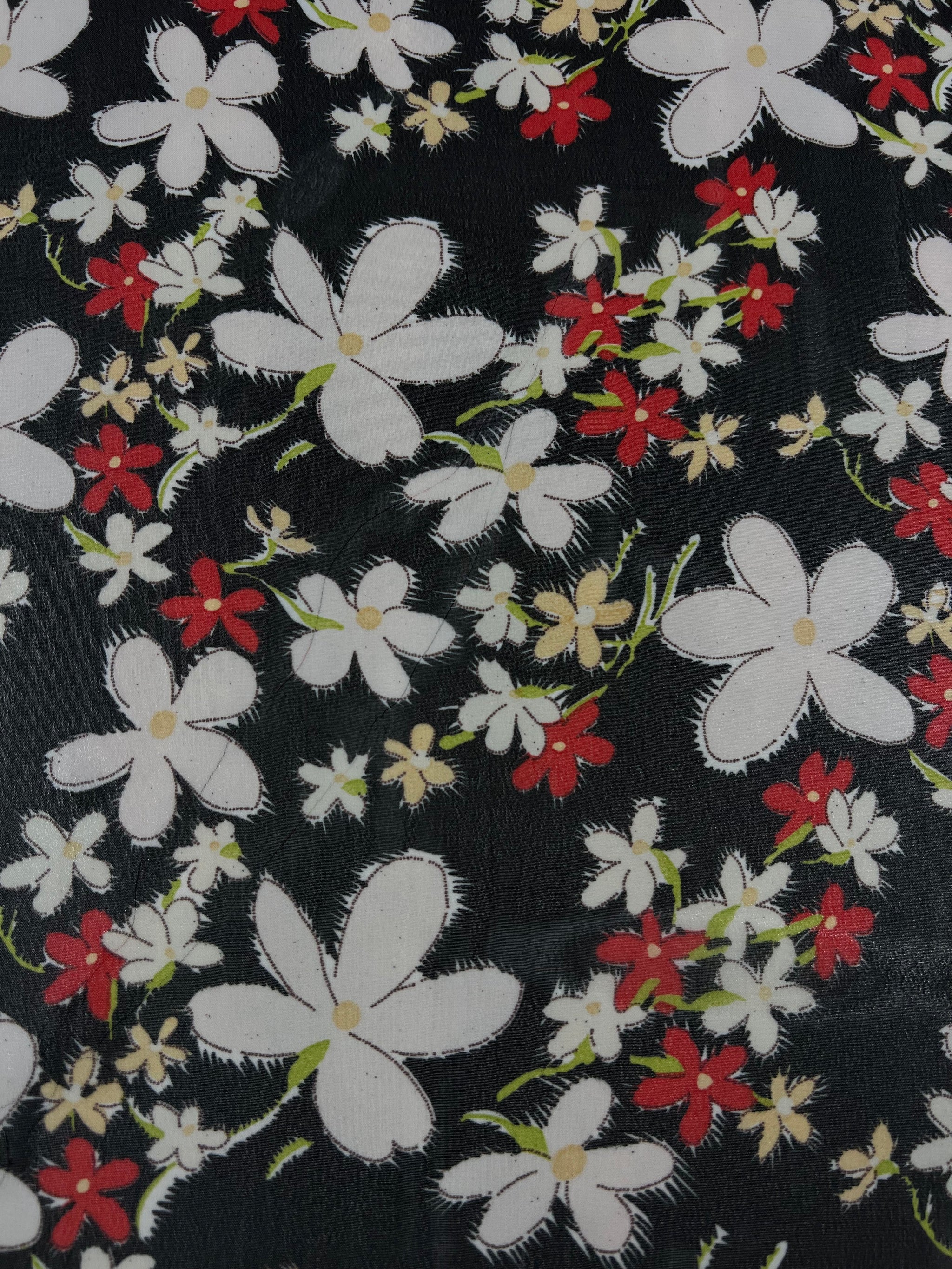 A vibrant design, featuring a floral pattern with white and red painted flowers accompanied by green stems and leaves set against a dark backdrop, the 